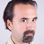A man with a dark goatee and mustache